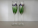 Two champagne flutes with floral design on a white background